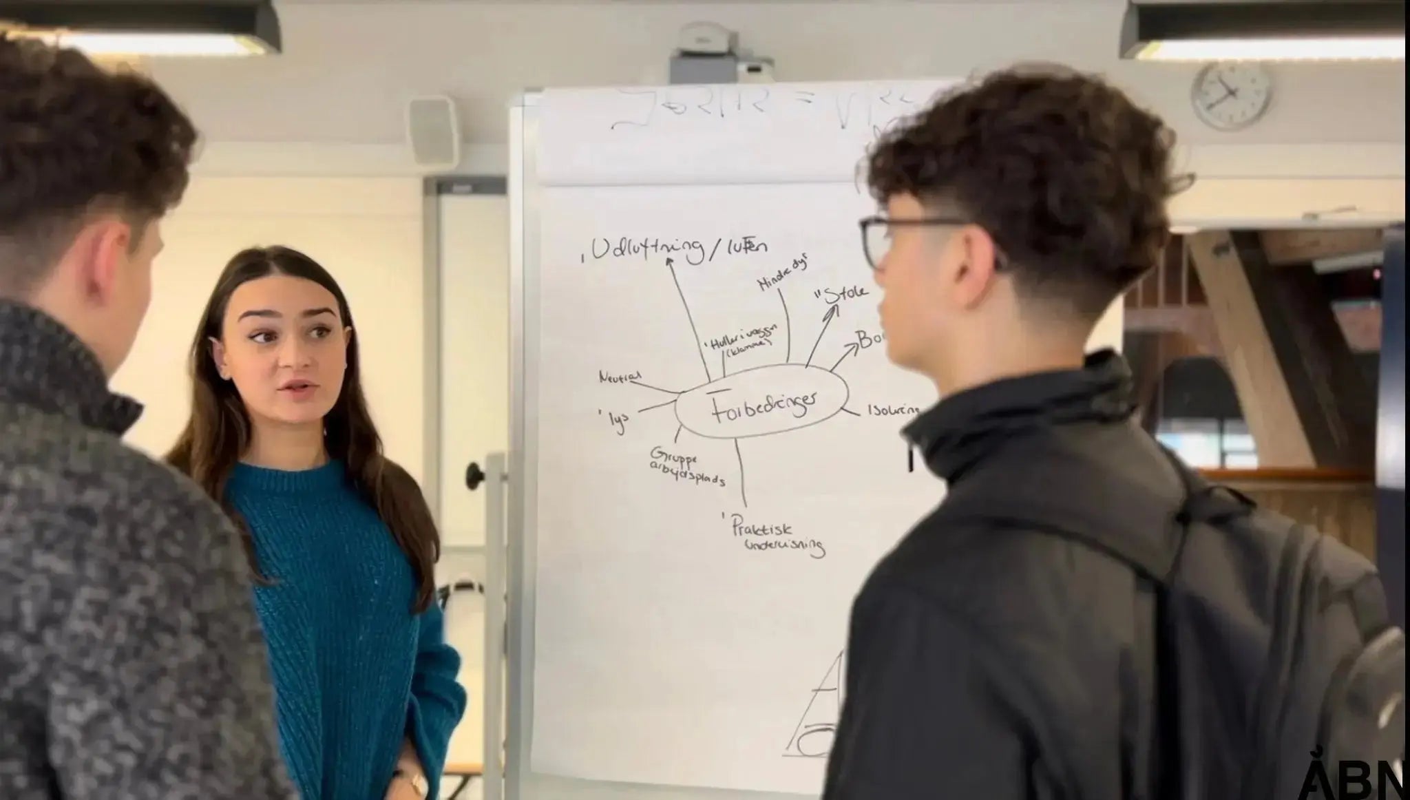 a group of people standing around a table 